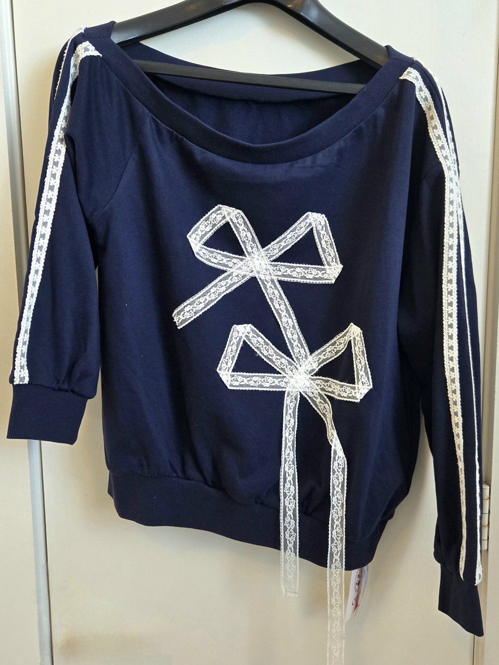 New Cider Navy Blue Off-Shoulder Sweatshirt with White Lace Bow Accents
